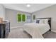Calming bedroom with large windows, soft carpeting, and neutral color palette at 10289 E Berry Dr, Greenwood Village, CO 80111