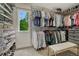 Spacious walk-in closet with ample shelving, hanging space, and a bright window at 10289 E Berry Dr, Greenwood Village, CO 80111