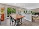 Cozy dining area featuring hardwood floors, a modern table, and access to a patio through sliding glass doors at 10289 E Berry Dr, Greenwood Village, CO 80111