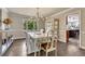Elegant dining room with hardwood floors, stylish lighting, and a view of the trees at 10289 E Berry Dr, Greenwood Village, CO 80111