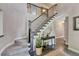 Staircase in a light-filled entryway with modern accents and stylish decor at 10289 E Berry Dr, Greenwood Village, CO 80111