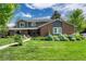 Charming two-story home with brick accents, a well-manicured lawn, and beautiful landscaping at 10289 E Berry Dr, Greenwood Village, CO 80111