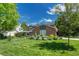 Charming two-story brick home with a beautiful lawn and manicured landscaping at 10289 E Berry Dr, Greenwood Village, CO 80111