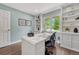 Bright home office featuring custom built-ins, a large window, and stylish decor at 10289 E Berry Dr, Greenwood Village, CO 80111
