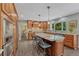 Spacious kitchen with granite countertops, a large island, custom cabinets, and stainless steel appliances at 10289 E Berry Dr, Greenwood Village, CO 80111