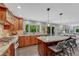 Spacious kitchen boasts granite countertops, stainless steel appliances, a center island, and ample cabinet space at 10289 E Berry Dr, Greenwood Village, CO 80111