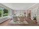 Bright living room featuring neutral paint, hardwood floors, large windows, and sophisticated decor at 10289 E Berry Dr, Greenwood Village, CO 80111