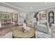 Open-concept living room with elegant decor, hardwood floors, and seamless flow to the dining area and staircase at 10289 E Berry Dr, Greenwood Village, CO 80111