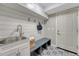 Functional mudroom featuring built-in storage, a utility sink, and eye-catching patterned flooring at 10289 E Berry Dr, Greenwood Village, CO 80111
