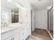 Well-lit bathroom with double vanity, modern fixtures, and a glass shower at 9266 Telluride Ct, Commerce City, CO 80022