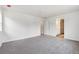 Spacious bedroom with plush gray carpet and an ensuite bathroom entrance at 9266 Telluride Ct, Commerce City, CO 80022