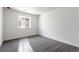 Bright bedroom featuring gray carpet and a window overlooking the neighborhood at 9266 Telluride Ct, Commerce City, CO 80022