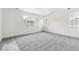 Bright bedroom with new carpeting and natural light from two windows at 9266 Telluride Ct, Commerce City, CO 80022