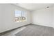 Well-lit bedroom with gray carpet and a large window offering neighborhood views at 9266 Telluride Ct, Commerce City, CO 80022
