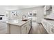 Modern kitchen with white cabinets, stainless steel appliances, and a large island at 9266 Telluride Ct, Commerce City, CO 80022