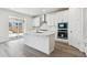 Modern kitchen featuring white cabinets, stainless appliances and a large island at 9266 Telluride Ct, Commerce City, CO 80022
