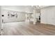 Open-concept living room with hardwood floors and a modern chandelier at 9266 Telluride Ct, Commerce City, CO 80022