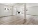 Open-concept living room with hardwood floors and modern fireplace at 9266 Telluride Ct, Commerce City, CO 80022