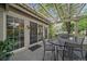 Outdoor deck area with a metal table and chairs underneath a lovely pergola at 4545 S Monaco St # 243, Denver, CO 80237