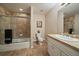Bathroom featuring tile surrounding the bathtub/shower, white toilet, and light countertop at 4545 S Monaco St # 243, Denver, CO 80237