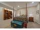 Bedroom showcases a four-poster bed, side table, built-in shelving, and a decorative trunk at 4545 S Monaco St # 243, Denver, CO 80237