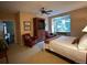 Relaxing primary bedroom featuring a ceiling fan, a large window, and an entertainment center at 4545 S Monaco St # 243, Denver, CO 80237