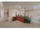 Spacious bedroom with a four-poster bed, side table, and decorations along the walls at 4545 S Monaco St # 243, Denver, CO 80237