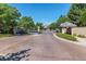 Gated community entrance featuring brick-paved road and lush greenery at 4545 S Monaco St # 243, Denver, CO 80237