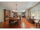 Elegant dining area with hardwood floors, chandelier lighting, and seamless transition to the modern kitchen at 4545 S Monaco St # 243, Denver, CO 80237