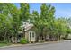 Inviting home exterior showcasing a cozy porch, bay window, and mature trees at 4545 S Monaco St # 243, Denver, CO 80237