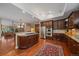 Open kitchen with island cooktop, stainless appliances, and hardwood floors at 4545 S Monaco St # 243, Denver, CO 80237