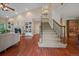 Spacious living room with fireplace, built-in bookshelves, and staircase at 4545 S Monaco St # 243, Denver, CO 80237