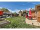 Large backyard featuring lush lawn, playset, and patio area at 9221 High St, Thornton, CO 80229