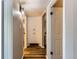 Hallway with hardwood floors and updated light fixtures at 9221 High St, Thornton, CO 80229