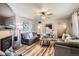 Cozy living room featuring hardwood floors, plush sofas, and a stylish ceiling fan at 9221 High St, Thornton, CO 80229