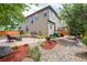 Landscaped backyard includes a brick patio, mulch beds, and grassy lawn at 11460 W Tanforan Cir, Littleton, CO 80127