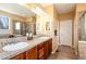 Elegant bathroom with double sinks, tiled countertops, and a glass-enclosed shower at 11460 W Tanforan Cir, Littleton, CO 80127