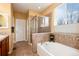 Relaxing bathroom featuring a soaking tub, separate shower, and modern fixtures at 11460 W Tanforan Cir, Littleton, CO 80127