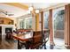 Elegant dining area featuring hardwood floors, large windows, and access to outdoor living space at 11460 W Tanforan Cir, Littleton, CO 80127