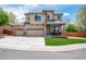 Beautiful two-story home featuring a three-car garage, well-maintained lawn, and a charming front porch at 11460 W Tanforan Cir, Littleton, CO 80127