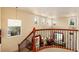 This home boasts a beautiful two-story foyer with natural light and a staircase at 11460 W Tanforan Cir, Littleton, CO 80127