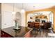 Open kitchen layout featuring a granite island, recessed lighting, and seamless living area access at 11460 W Tanforan Cir, Littleton, CO 80127
