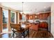 Eat-in kitchen has rich wood cabinets, stainless appliances, and sliding doors to the backyard at 11460 W Tanforan Cir, Littleton, CO 80127