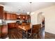 Kitchen with dark hardwood floors, stainless steel appliances, and a view of the staircase at 11460 W Tanforan Cir, Littleton, CO 80127