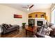 A warm living room featuring hardwood floors, a cozy fireplace, and natural light at 11460 W Tanforan Cir, Littleton, CO 80127