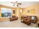 Cozy living room with two comfortable sofas, large windows, and neighborhood views at 11460 W Tanforan Cir, Littleton, CO 80127