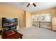 View of the open floor plan featuring a large living room area with a TV and ceiling fan at 11460 W Tanforan Cir, Littleton, CO 80127