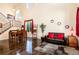 Spacious living room with hardwood floors, large windows, and staircase access at 11460 W Tanforan Cir, Littleton, CO 80127