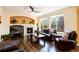 A cozy living room showcasing a fireplace, large windows, and hardwood floors at 11460 W Tanforan Cir, Littleton, CO 80127