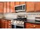 This kitchen features a stainless steel range, granite countertops and decorative tile backsplash at 11460 W Tanforan Cir, Littleton, CO 80127